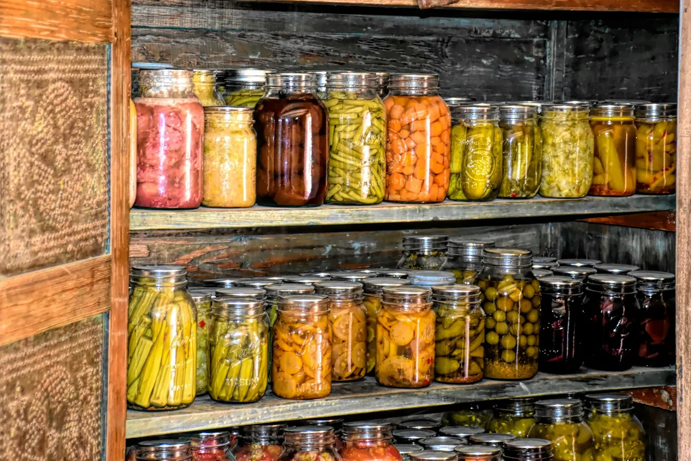 Pantry shelves filled with home-preserved food in glass jars